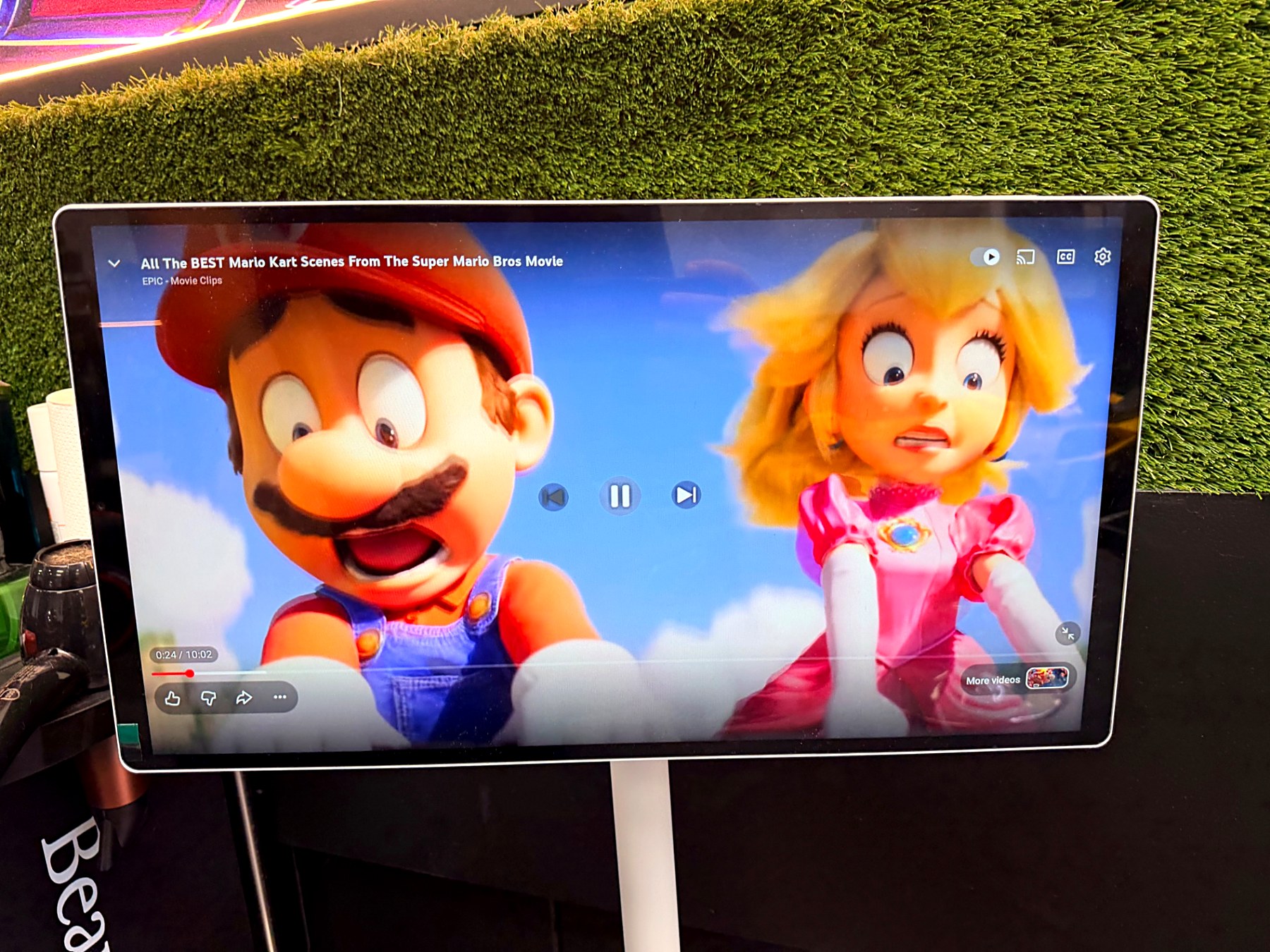 Portable screen playing a Mario movie clip during a kids haircut